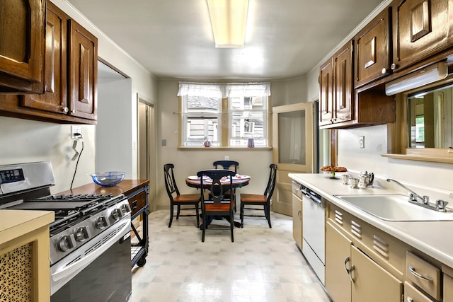 83 W 38th St, Bayonne, NJ 07002 - kitchen with gas range, white dishwasher, light countertops, light floors, and dark brown cabinets