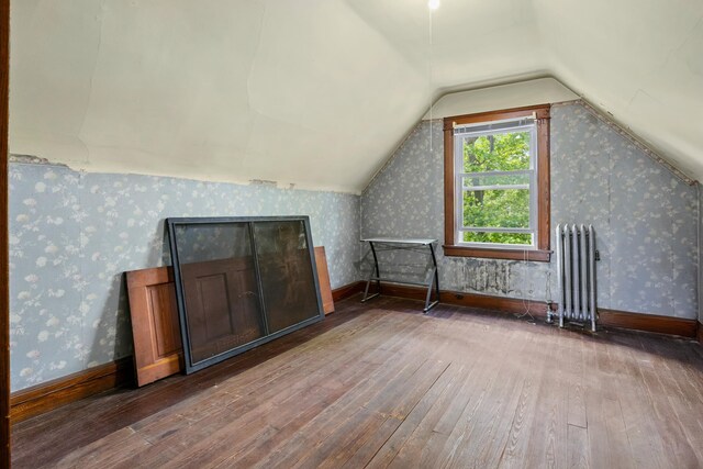 83 W 38th St, Bayonne, NJ 07002 - additional living space with radiator, hardwood / wood-style floors, lofted ceiling, and wallpapered walls