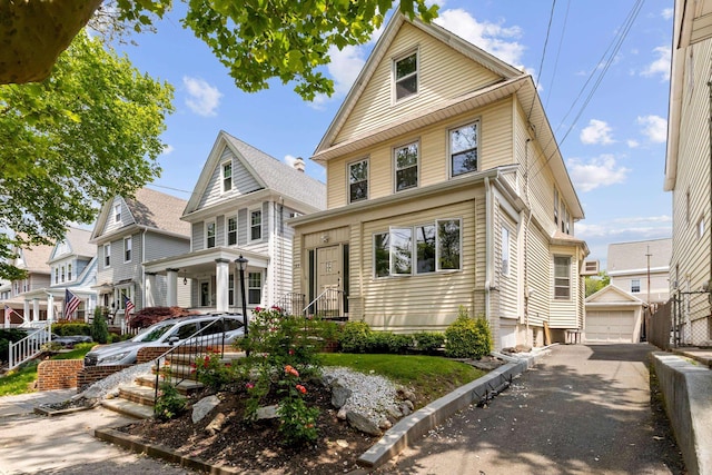 83 W 38th St, Bayonne, NJ 07002 - traditional style home with a porch, a detached garage, and an outbuilding