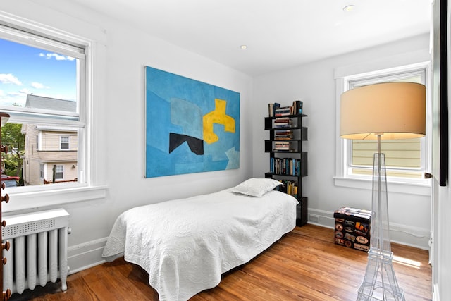 83 W 38th St, Bayonne, NJ 07002 - bedroom with radiator and wood finished floors