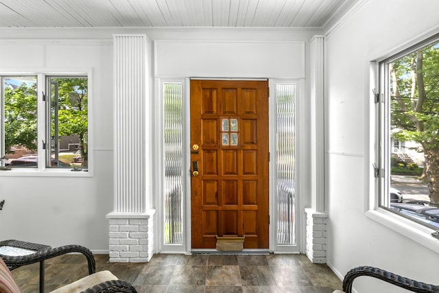 83 W 38th St, Bayonne, NJ 07002 - foyer featuring decorative columns, crown molding, stone finish flooring, and wood ceiling