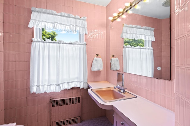 83 W 38th St, Bayonne, NJ 07002 - bathroom with radiator heating unit, tile walls, and vanity