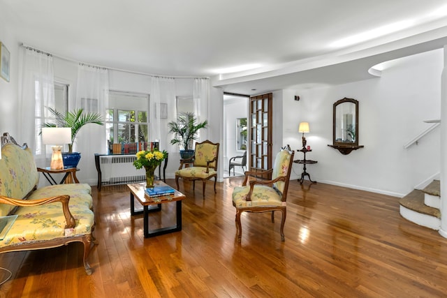 83 W 38th St, Bayonne, NJ 07002 - sitting room featuring radiator, wood finished floors, and stairway