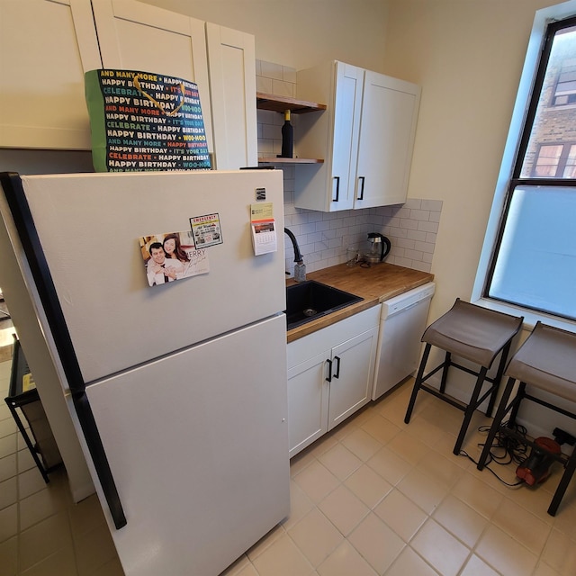 kitchen featuring open shelves, white appliances, a sink, and white cabinetry