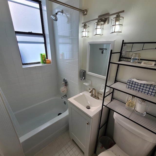 bathroom featuring toilet, vanity, tile walls, tasteful backsplash, and washtub / shower combination