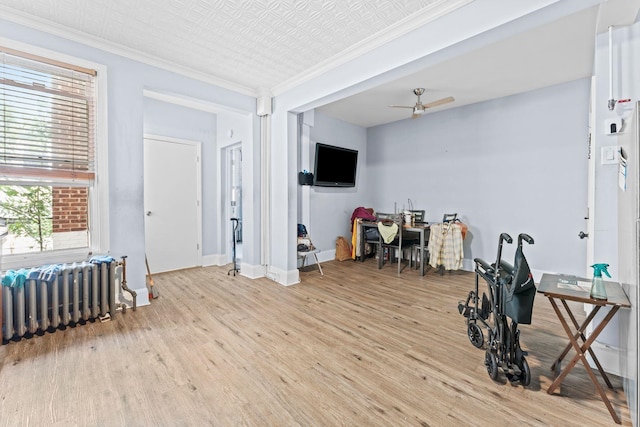 6113 Washington St, West New York, NJ 07093 - home office with radiator heating unit, a ceiling fan, light wood-type flooring, and ornamental molding