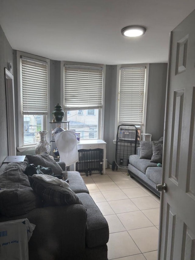 6113 Washington St, West New York, NJ 07093 - living area with radiator heating unit and light tile patterned floors