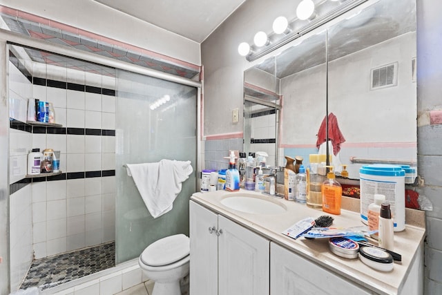 6113 Washington St, West New York, NJ 07093 - full bathroom with a shower stall, vanity, and tile walls