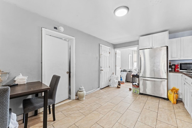 6113 Washington St, West New York, NJ 07093 - kitchen featuring stainless steel appliances, white cabinetry, dark countertops, and light tile patterned floors