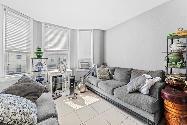 6113 Washington St, West New York, NJ 07093 - living room featuring tile patterned floors, cooling unit, and radiator