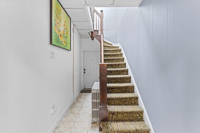 6113 Washington St, West New York, NJ 07093 - stairway with baseboards and tile patterned floors