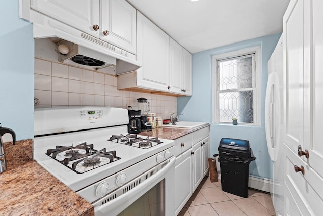 6113 Washington St, West New York, NJ 07093 - kitchen with white gas range oven, under cabinet range hood, white cabinetry, light tile patterned flooring, and light countertops