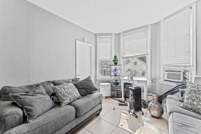 6113 Washington St, West New York, NJ 07093 - living room featuring a textured wall, cooling unit, and light tile patterned floors
