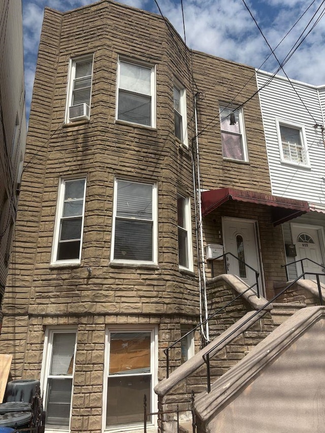 6113 Washington St, West New York, NJ 07093 - view of home's exterior with stone siding and cooling unit