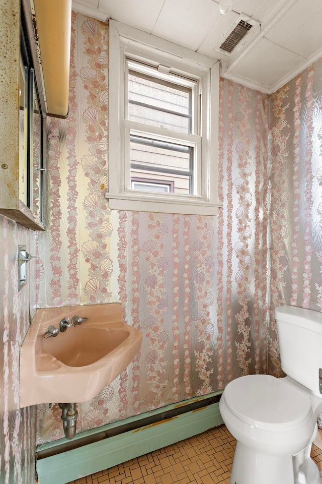 6 Stegman Pl, Jersey City, NJ 07305 - bathroom featuring wallpapered walls, toilet, and a sink