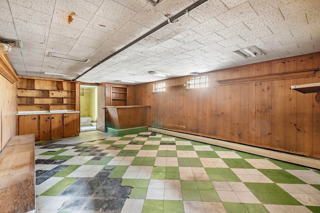 6 Stegman Pl, Jersey City, NJ 07305 - below grade area featuring wood walls, tile patterned floors, and a baseboard radiator