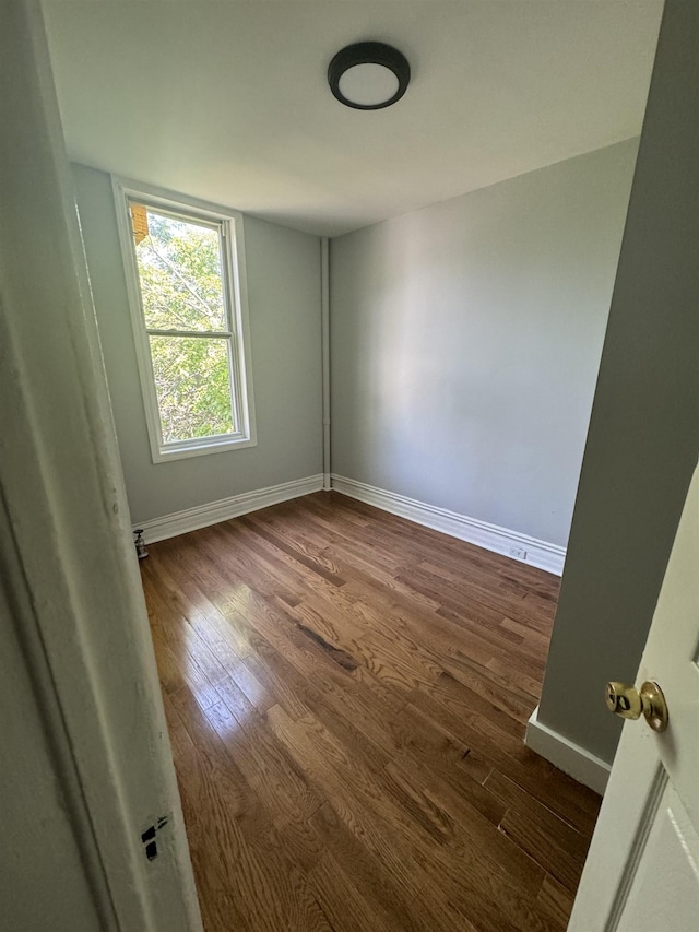 unfurnished room featuring dark hardwood / wood-style floors