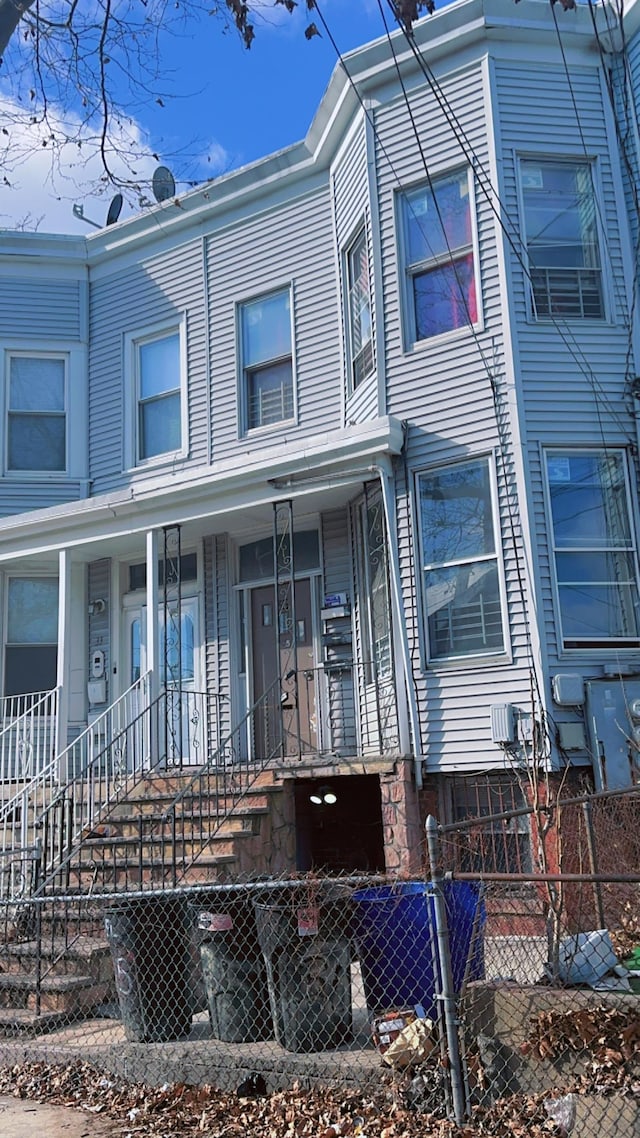 townhome / multi-family property featuring a porch