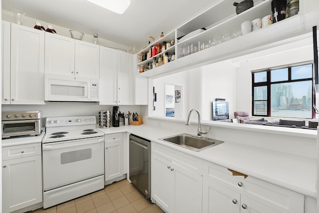 1500 Hudson St Unit 7H, Hoboken, NJ 07030 - kitchen with white appliances, light tile patterned floors, white cabinetry, light countertops, and open shelves