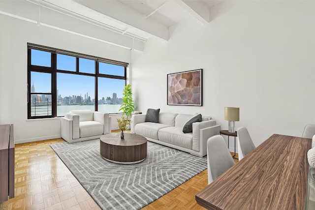 1500 Hudson St Unit 7H, Hoboken, NJ 07030 - living area with beam ceiling, a towering ceiling, and a view of skyline