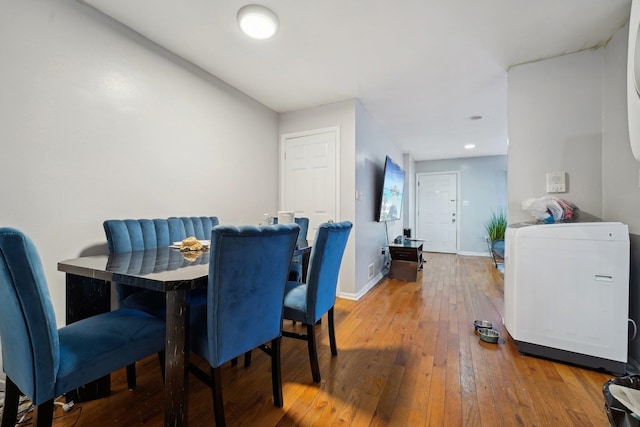 dining space with wood-type flooring