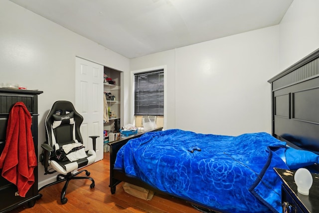 bedroom featuring hardwood / wood-style floors and cooling unit