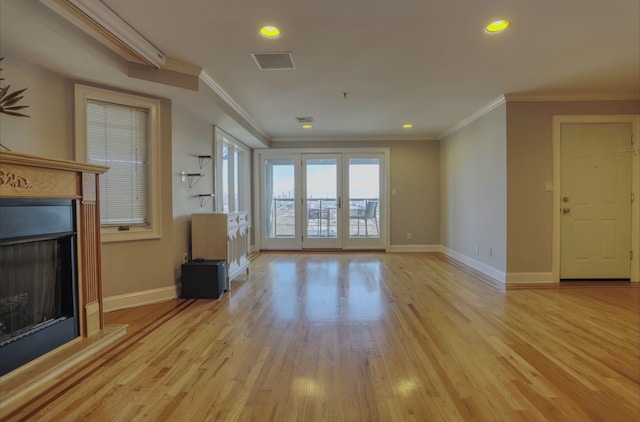 unfurnished living room with light wood-type flooring and crown molding