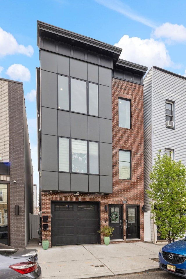 1163 Summit Ave Unit 2, Jersey City, NJ 07307 - view of front facade with brick siding, an attached garage, concrete driveway, and cooling unit