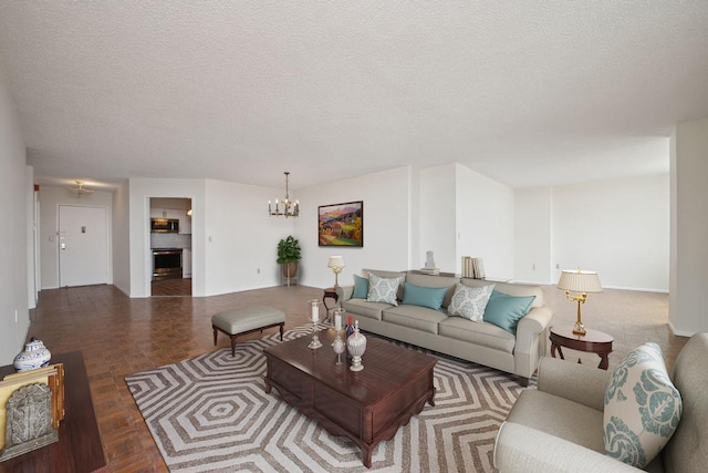 living area featuring a textured ceiling, a fireplace, and a notable chandelier