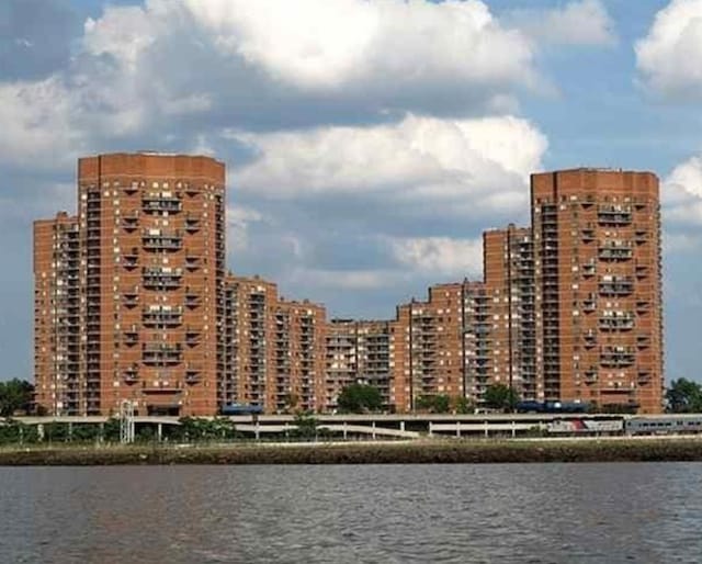 view of property with a water view and a city view