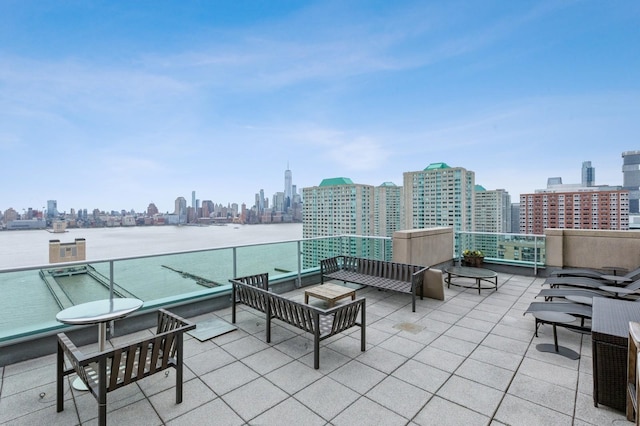 view of patio / terrace featuring a balcony and a water view