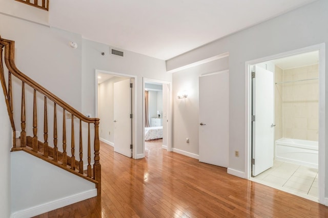 interior space featuring connected bathroom and light hardwood / wood-style flooring