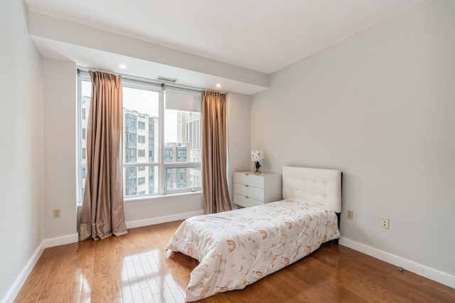 bedroom with hardwood / wood-style floors