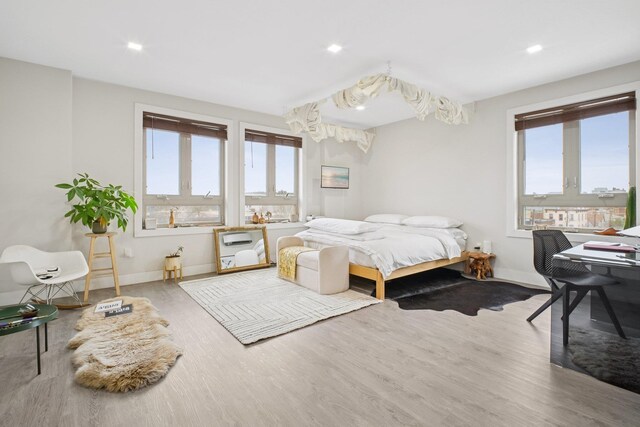 bedroom with baseboards, recessed lighting, and wood finished floors