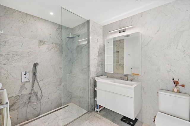 bathroom featuring toilet, vanity, tile walls, and tiled shower