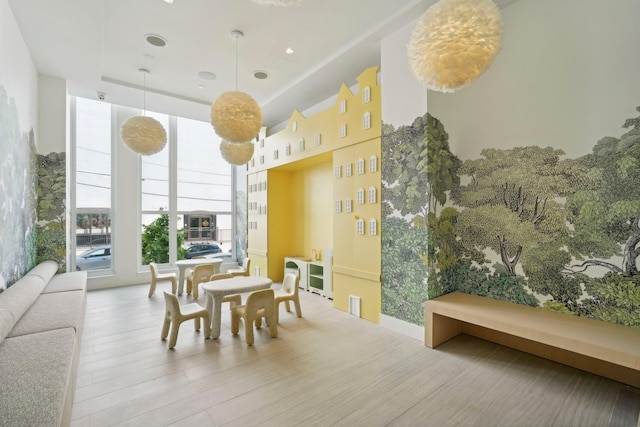 sunroom / solarium featuring a raised ceiling