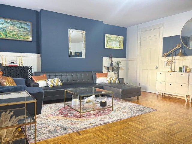 living room with a decorative wall and wainscoting