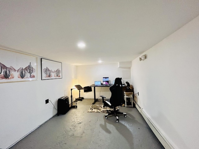 home office with a baseboard radiator and concrete floors