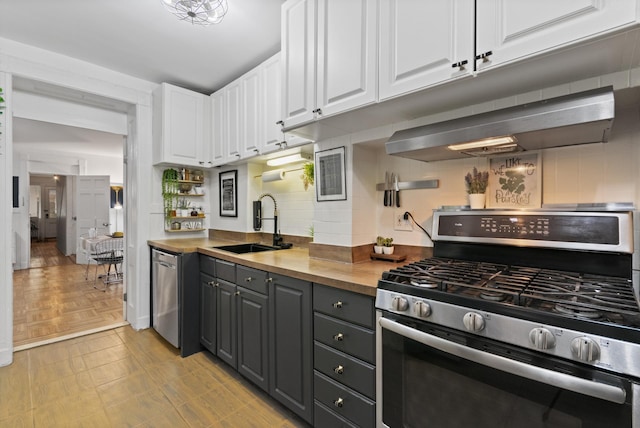 258 Montgomery St Unit 0, Jersey City, NJ 07302 - kitchen featuring stainless steel appliances, a sink, wall chimney range hood, white cabinetry, and gray cabinets