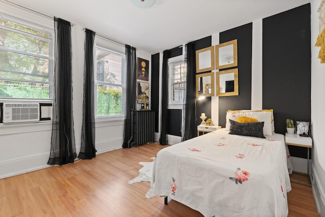 258 Montgomery St Unit 0, Jersey City, NJ 07302 - bedroom featuring cooling unit, wood finished floors, radiator heating unit, and baseboards