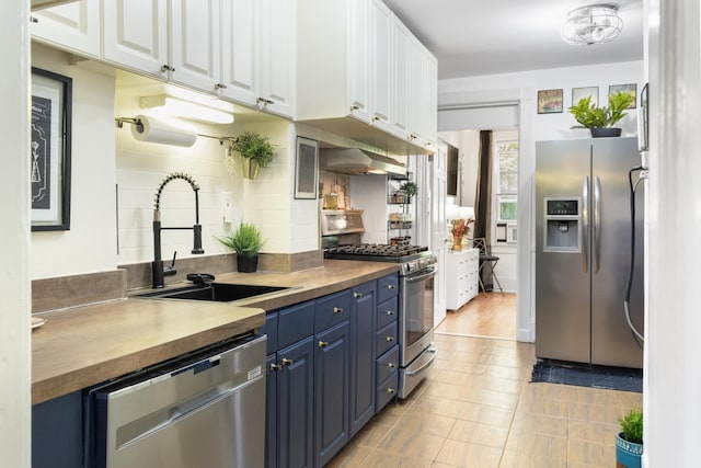 258 Montgomery St Unit 0, Jersey City, NJ 07302 - kitchen with stainless steel appliances, blue cabinets, a sink, and butcher block countertops