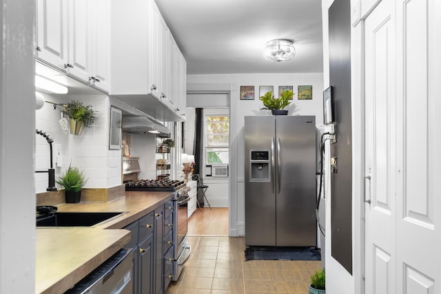 258 Montgomery St Unit 0, Jersey City, NJ 07302 - kitchen with stainless steel appliances, white cabinets, cooling unit, light tile patterned flooring, and blue cabinetry