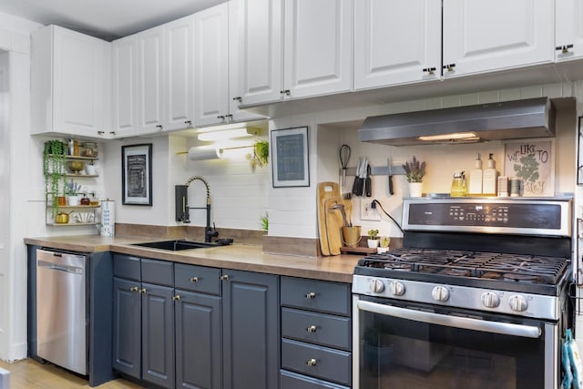 258 Montgomery St Unit 0, Jersey City, NJ 07302 - kitchen with stainless steel appliances, a sink, blue cabinets, and white cabinetry