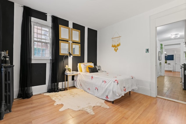 258 Montgomery St Unit 0, Jersey City, NJ 07302 - bedroom with wood finished floors, baseboards, and radiator heating unit