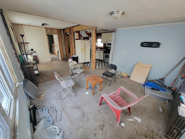 interior space featuring a healthy amount of sunlight, white fridge with ice dispenser, and crown molding