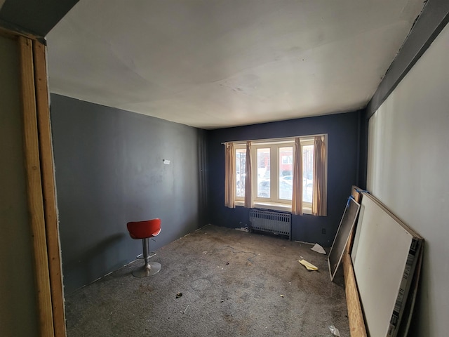 carpeted spare room featuring radiator