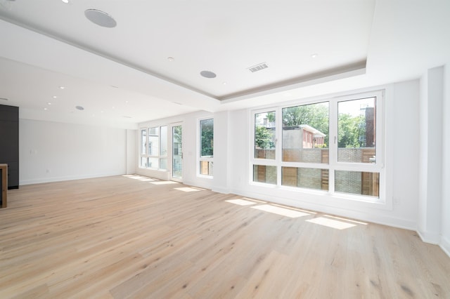 209 6th St Unit 1, Hoboken, NJ 07030 - unfurnished living room with light wood-style flooring, baseboards, and a tray ceiling