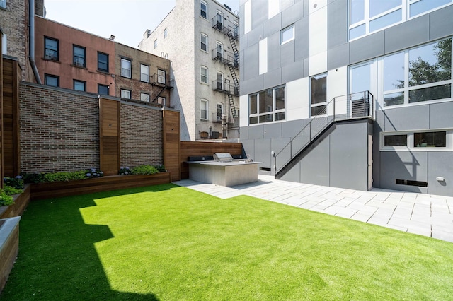 209 6th St Unit 1, Hoboken, NJ 07030 - rear view of house featuring an outdoor kitchen, a yard, and an AC wall unit