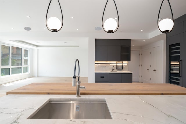 209 6th St Unit 1, Hoboken, NJ 07030 - kitchen featuring a sink, modern cabinets, a tray ceiling, hanging light fixtures, and recessed lighting