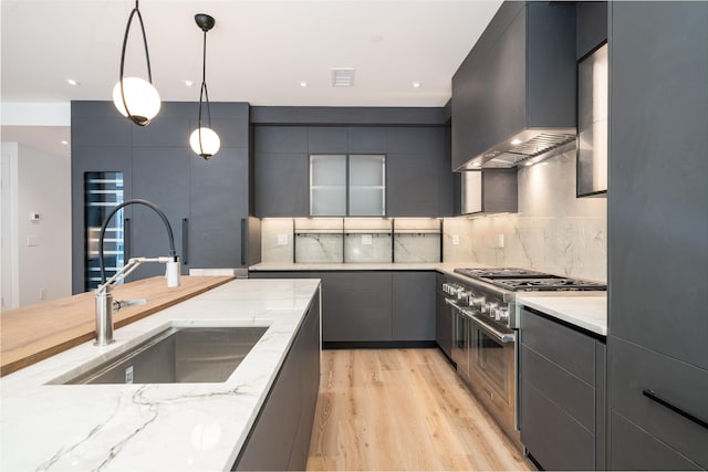 209 6th St Unit 1, Hoboken, NJ 07030 - kitchen featuring wall chimney exhaust hood, a sink, gray cabinetry, modern cabinets, and recessed lighting